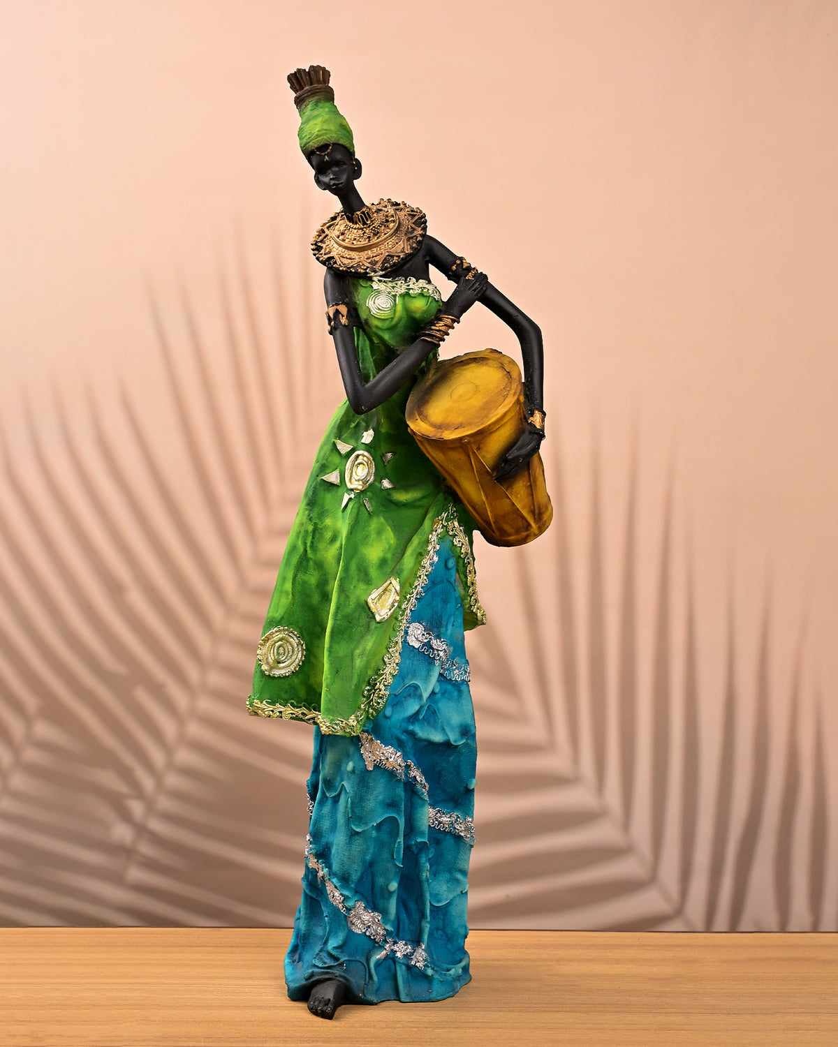 African woman holding drum statue with traditional design