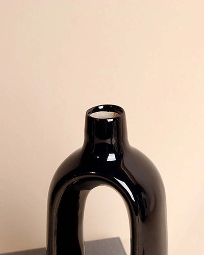 Minimalist black vase with a unique open hollow shape
