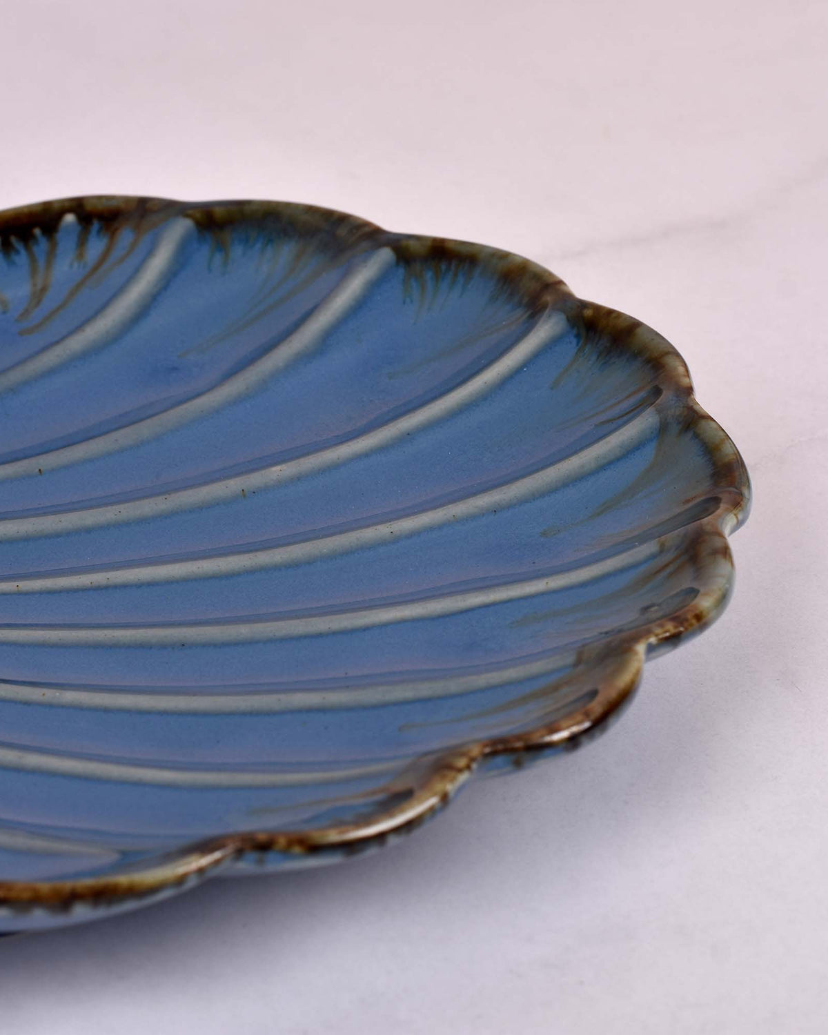 Decorative blue ceramic platter with shell design