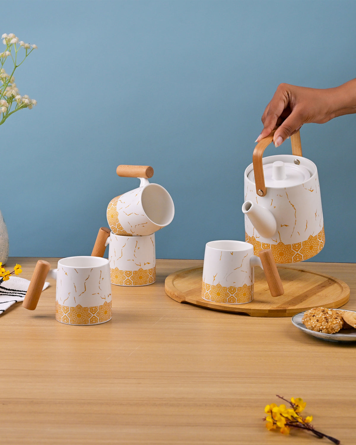Bronze Decor White Tea Set Displayed on a Dining Table