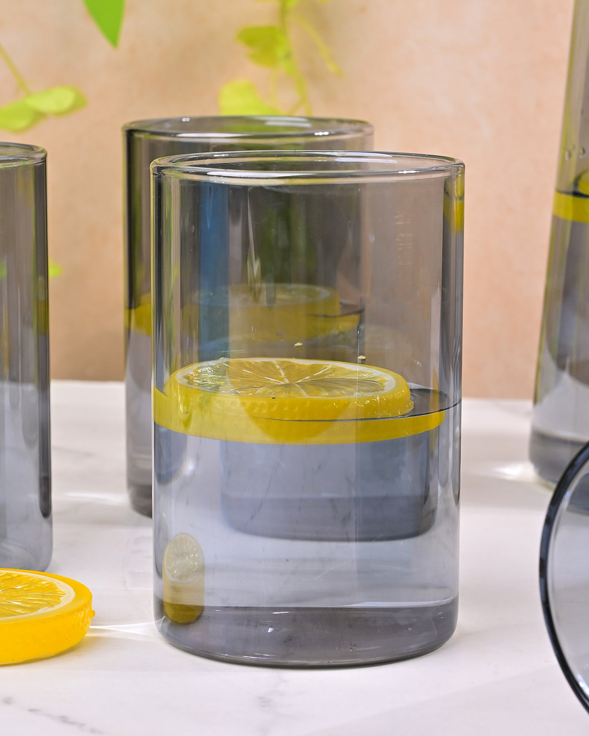 Elegant glass pitcher with gold lid for serving water and juice
