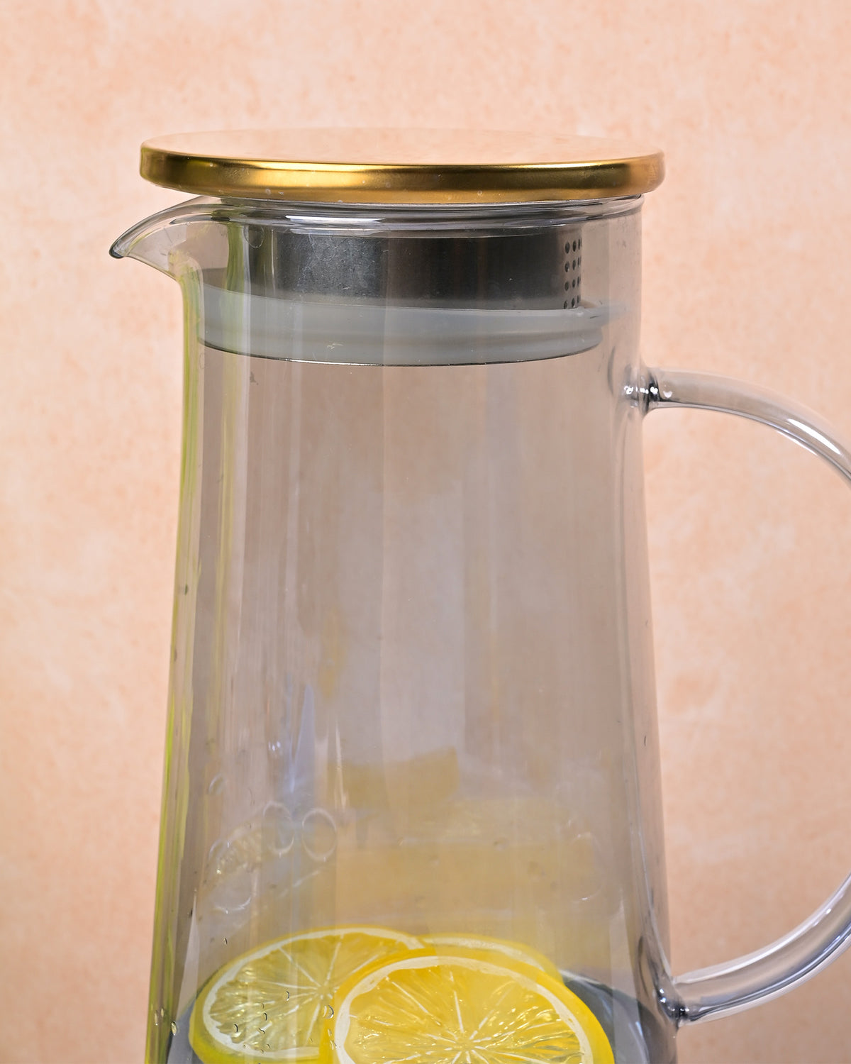 Stylish glass water bottle carafe with gold-tone lid for home use