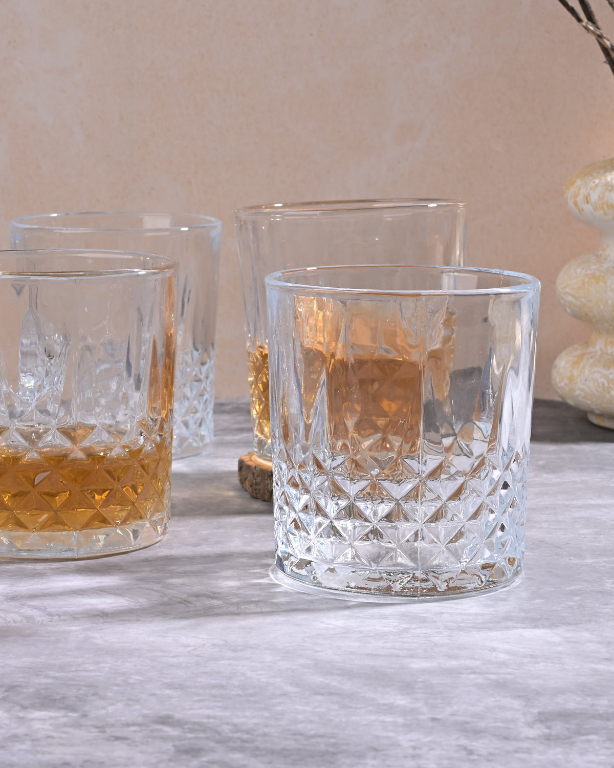 Four classic whiskey glasses displayed on a table