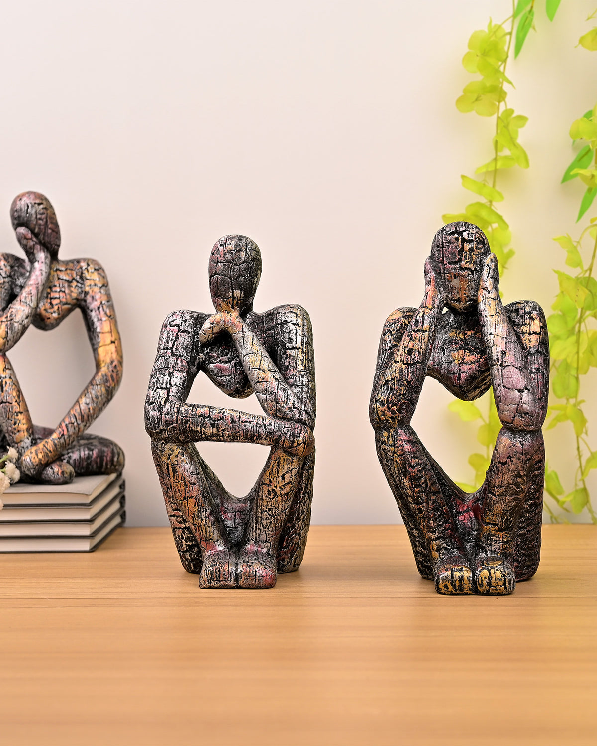 Copper-finish abstract human figurines in three different poses