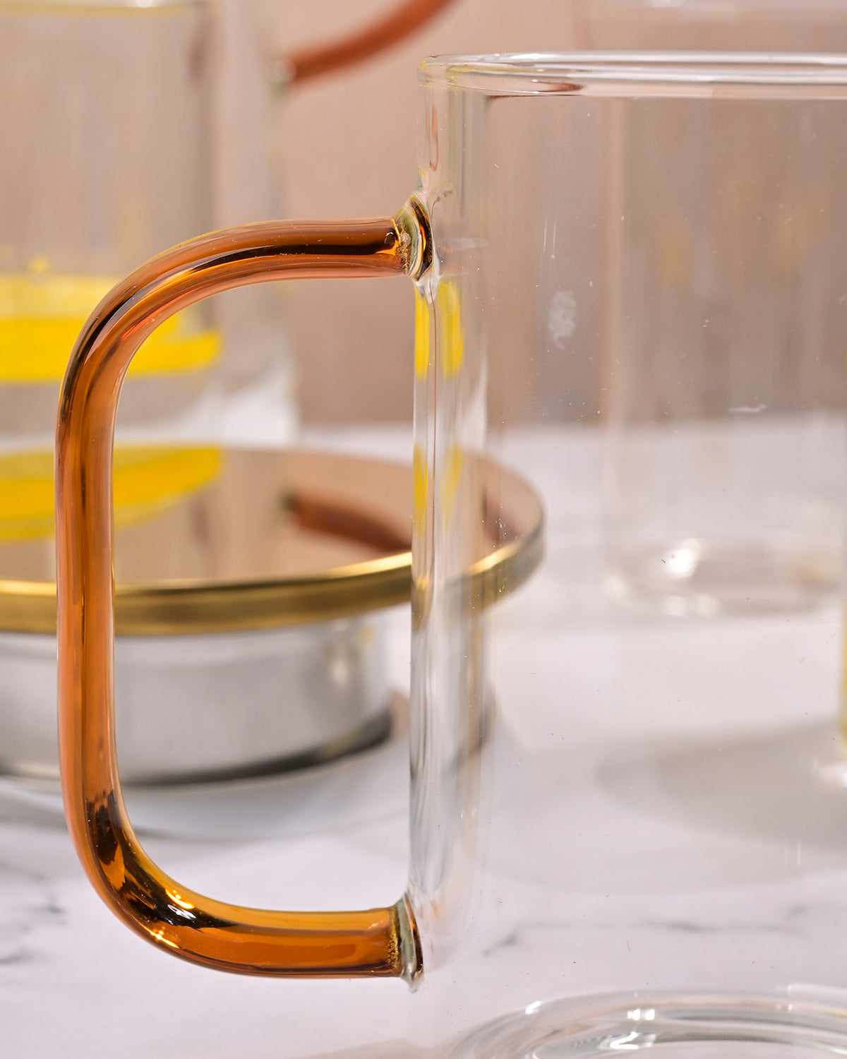 Elegant glass pitcher and mug set displayed on a dining table