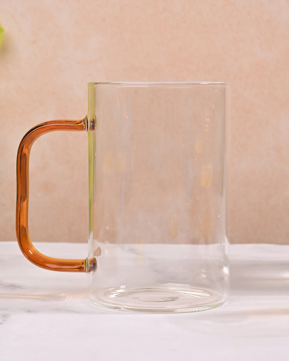 Elegant beverage serving set featuring a clear glass pitcher and mugs