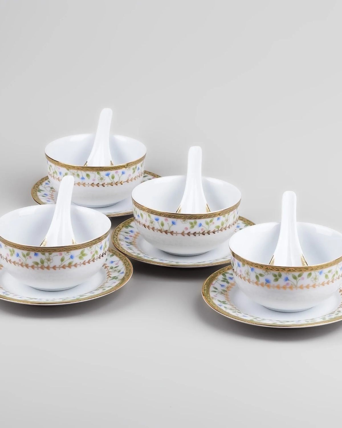 Decorative porcelain bowls with matching spoons for serving