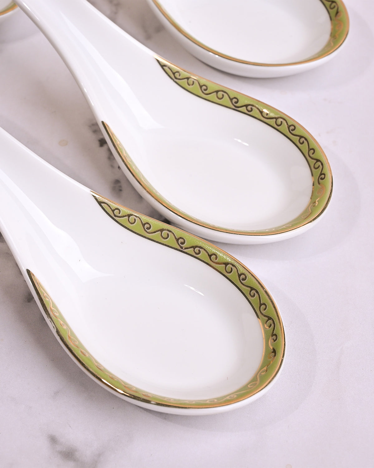 Set of four porcelain bowls with matching ceramic spoons