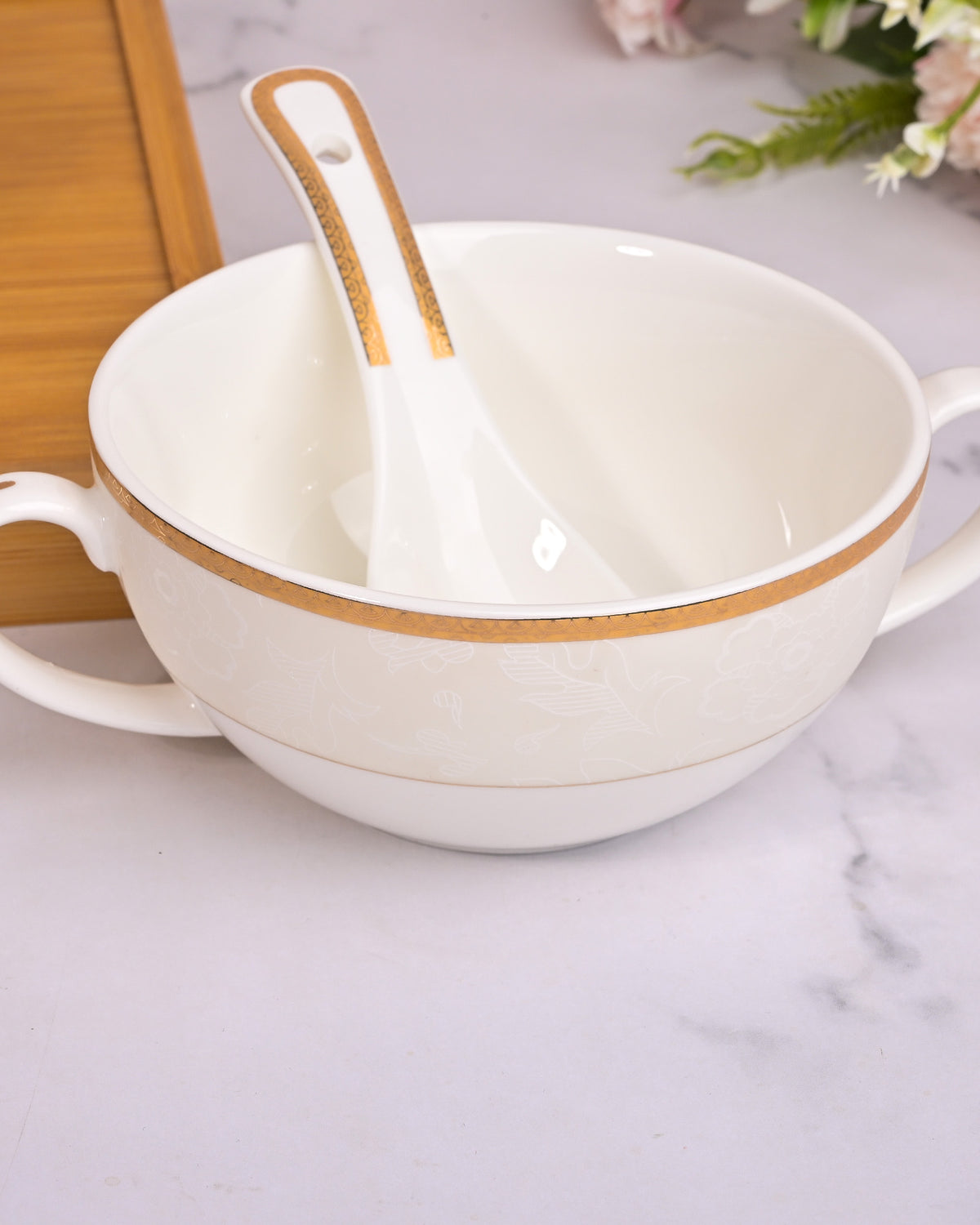 Elegant white soup bowls with matching spoons