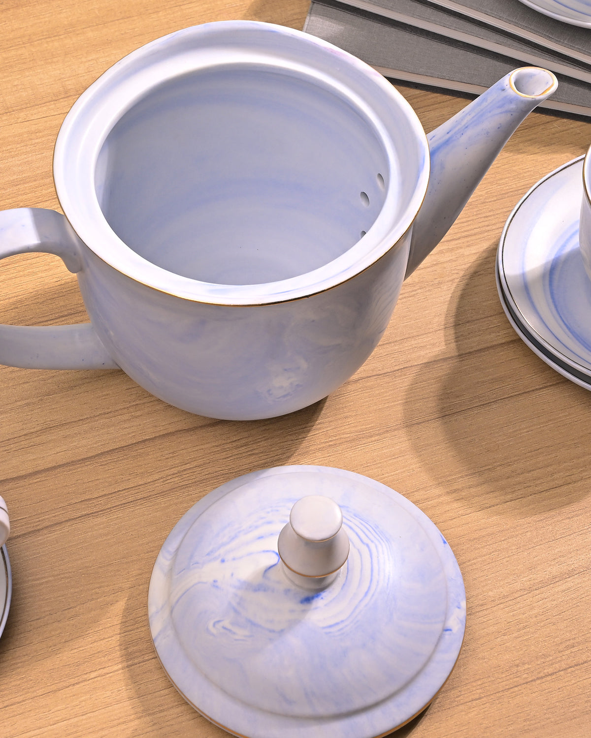 Faded blue ceramic tea kettle