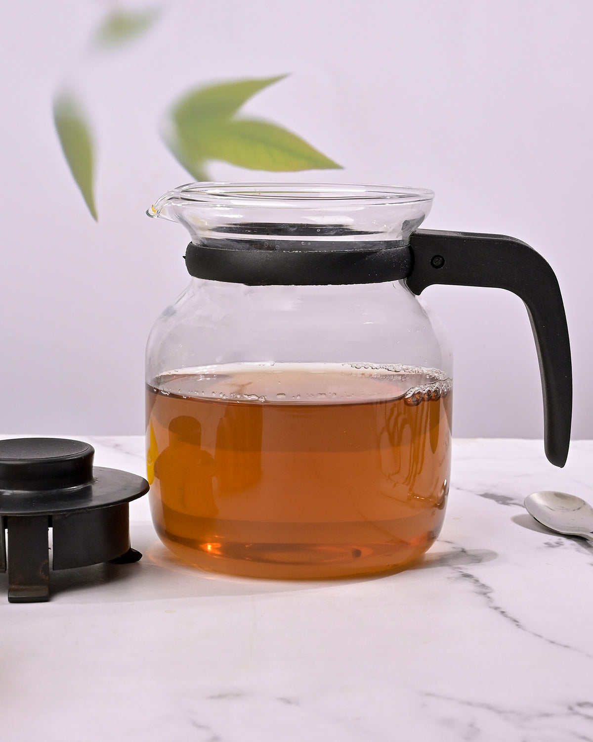 Transparent glass teapot with black handle
