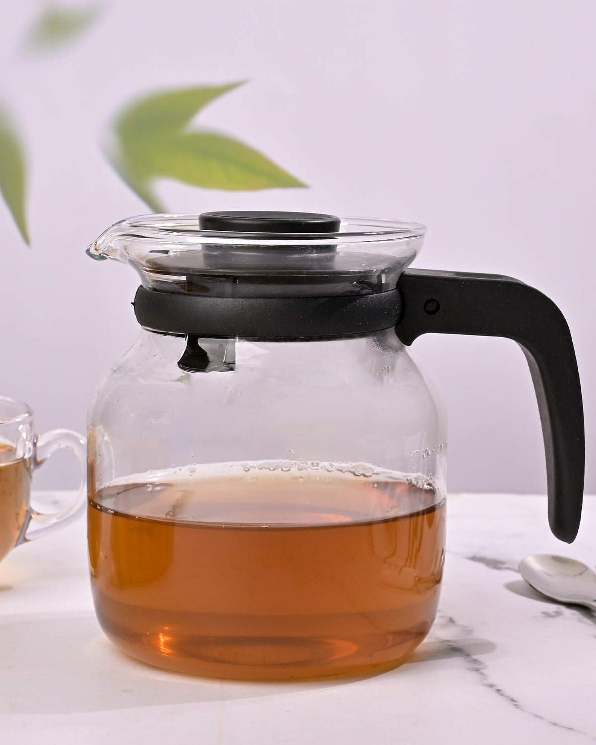 Glass tea brewing pot with black handle
