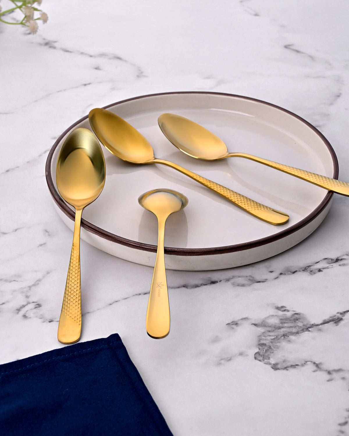 Close-Up of Golden Steel Spoons with Hammered Texture