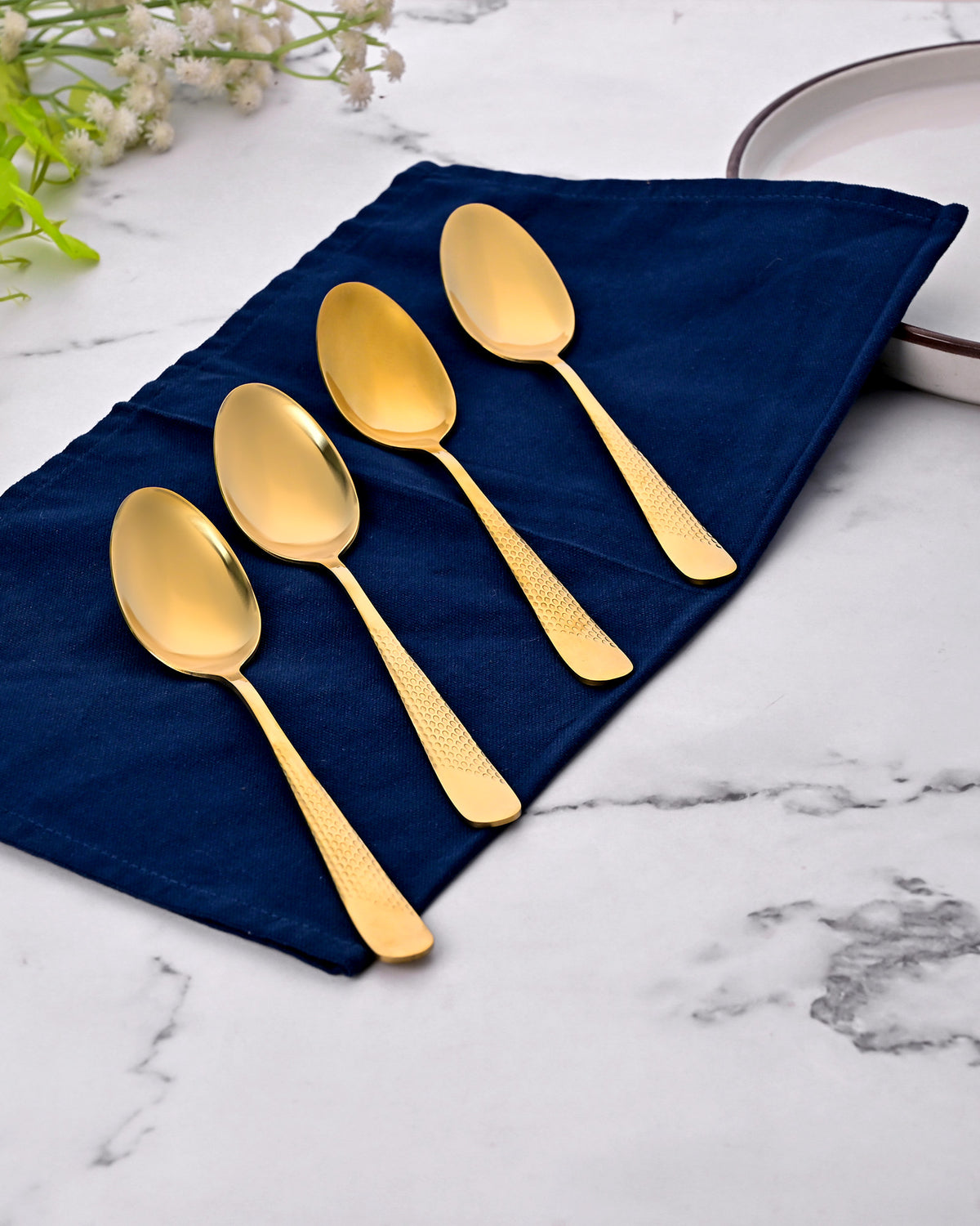 Golden Hammered Steel Spoons Set of 4 Displayed Elegantly