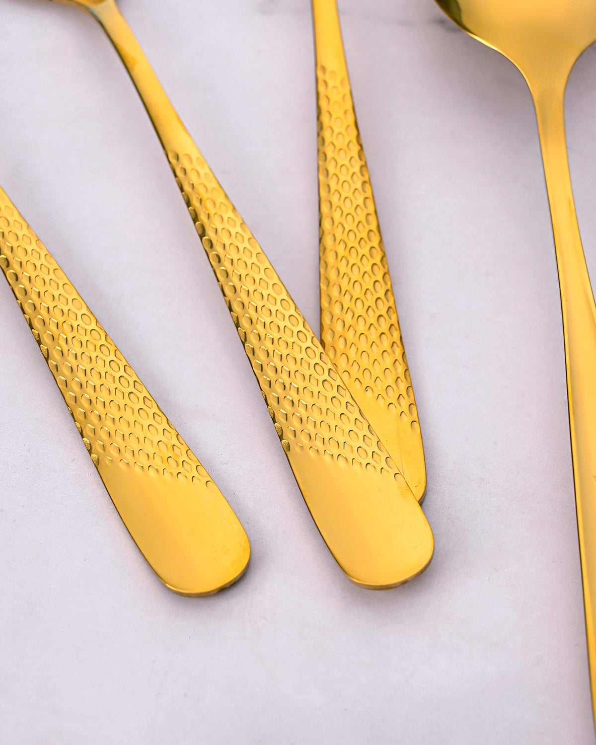 Elegant Gold Steel Spoons Featuring a Unique Hammered Design