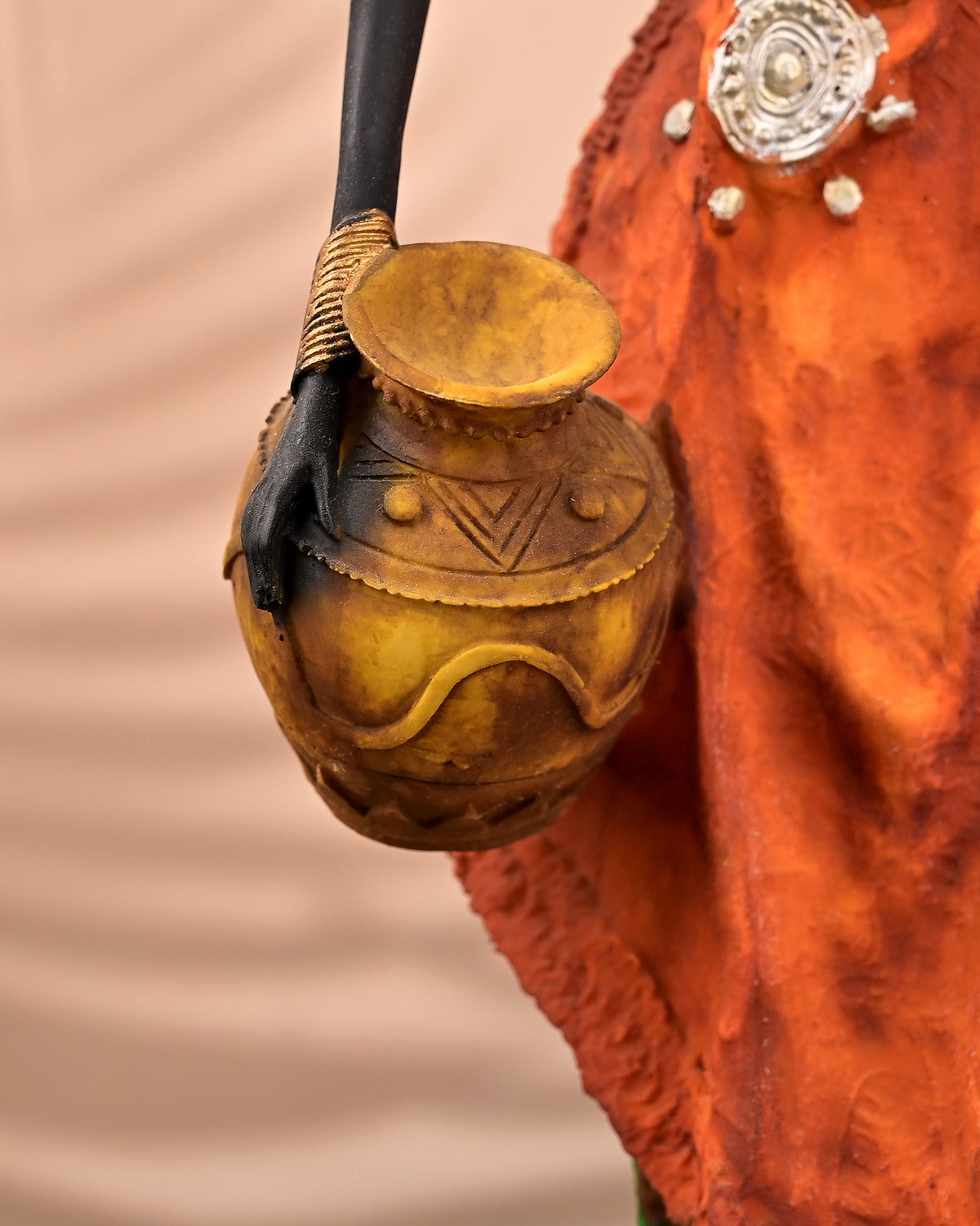 Elegant ethnic woman sculpture with a golden finish