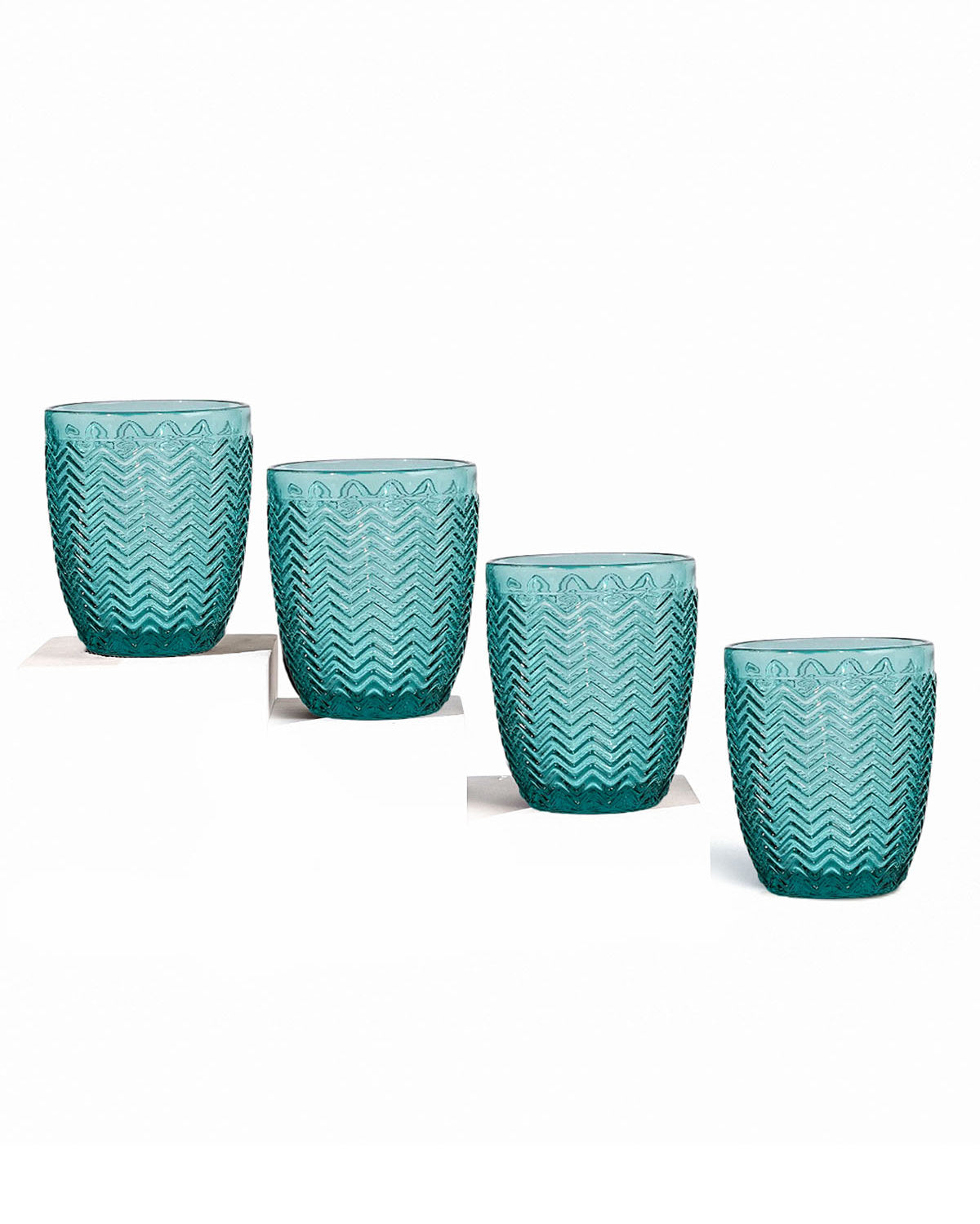 Four Midori clear drinking glasses on display