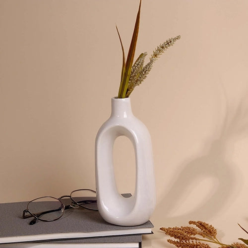 Minimalist white hollow vase with modern sculptural design