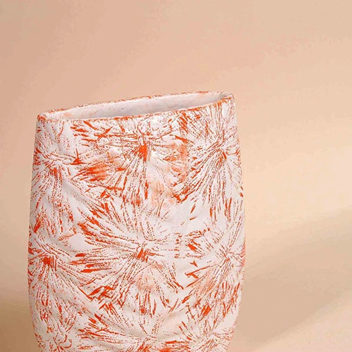 Textured peach vase with intricate botanical leaf detailing