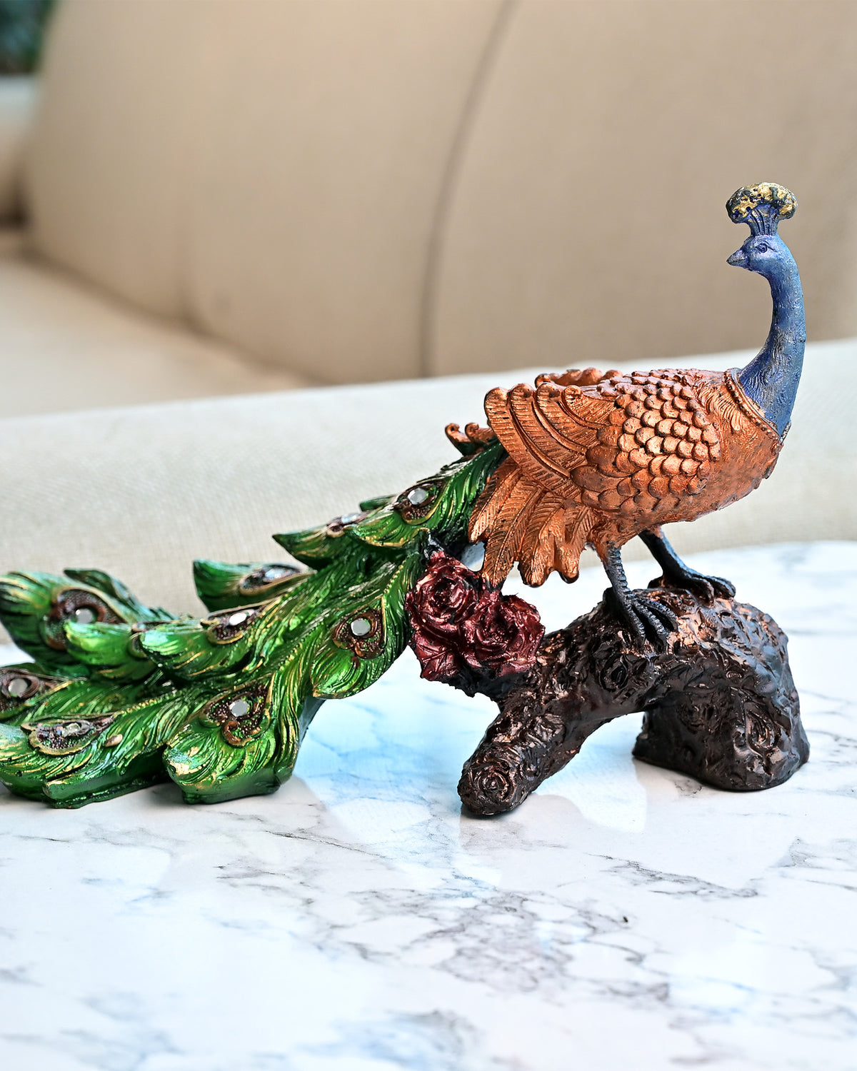 Peacock on tree trunk statue with detailed feather design