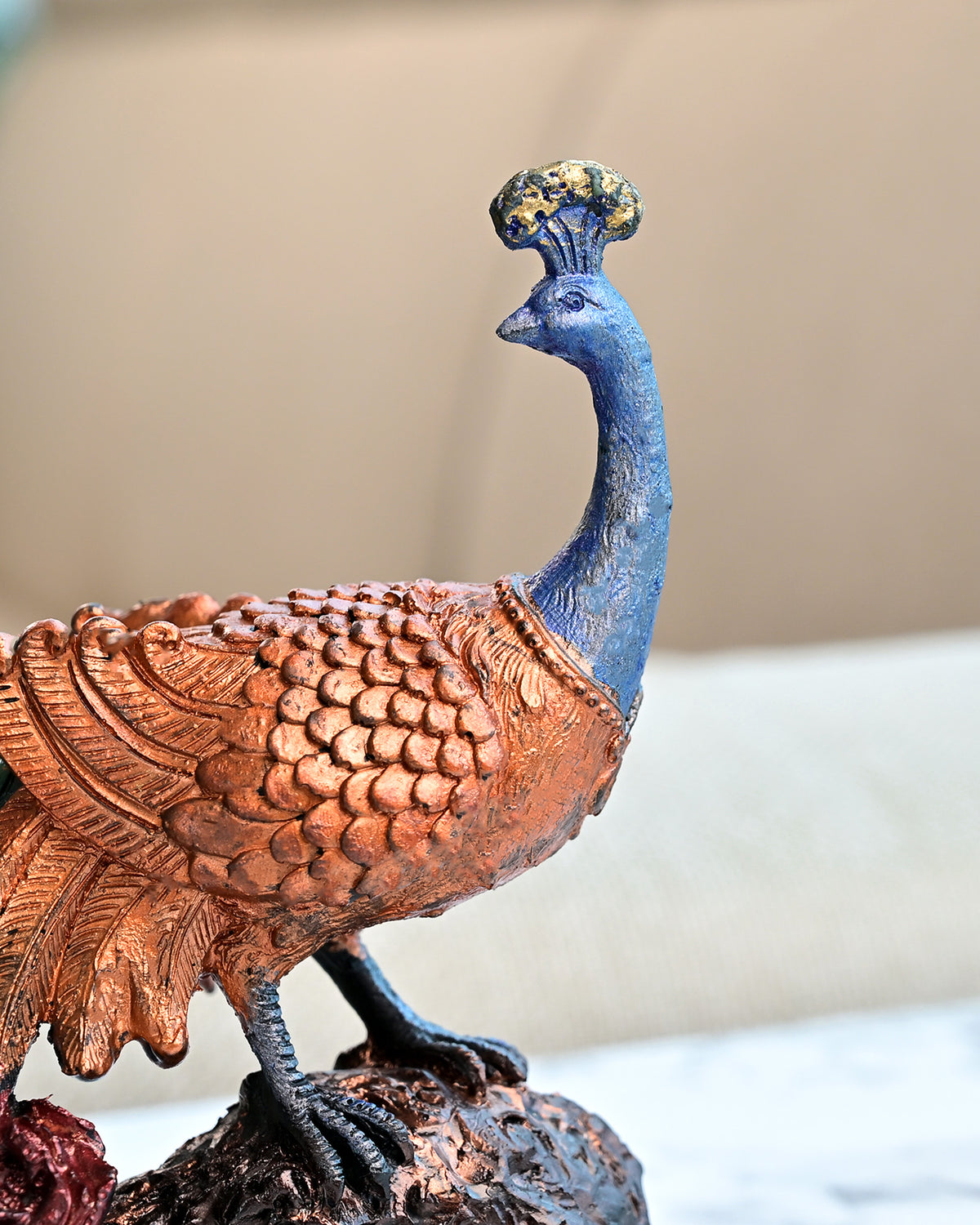 Decorative peacock statue carved on a tree trunk