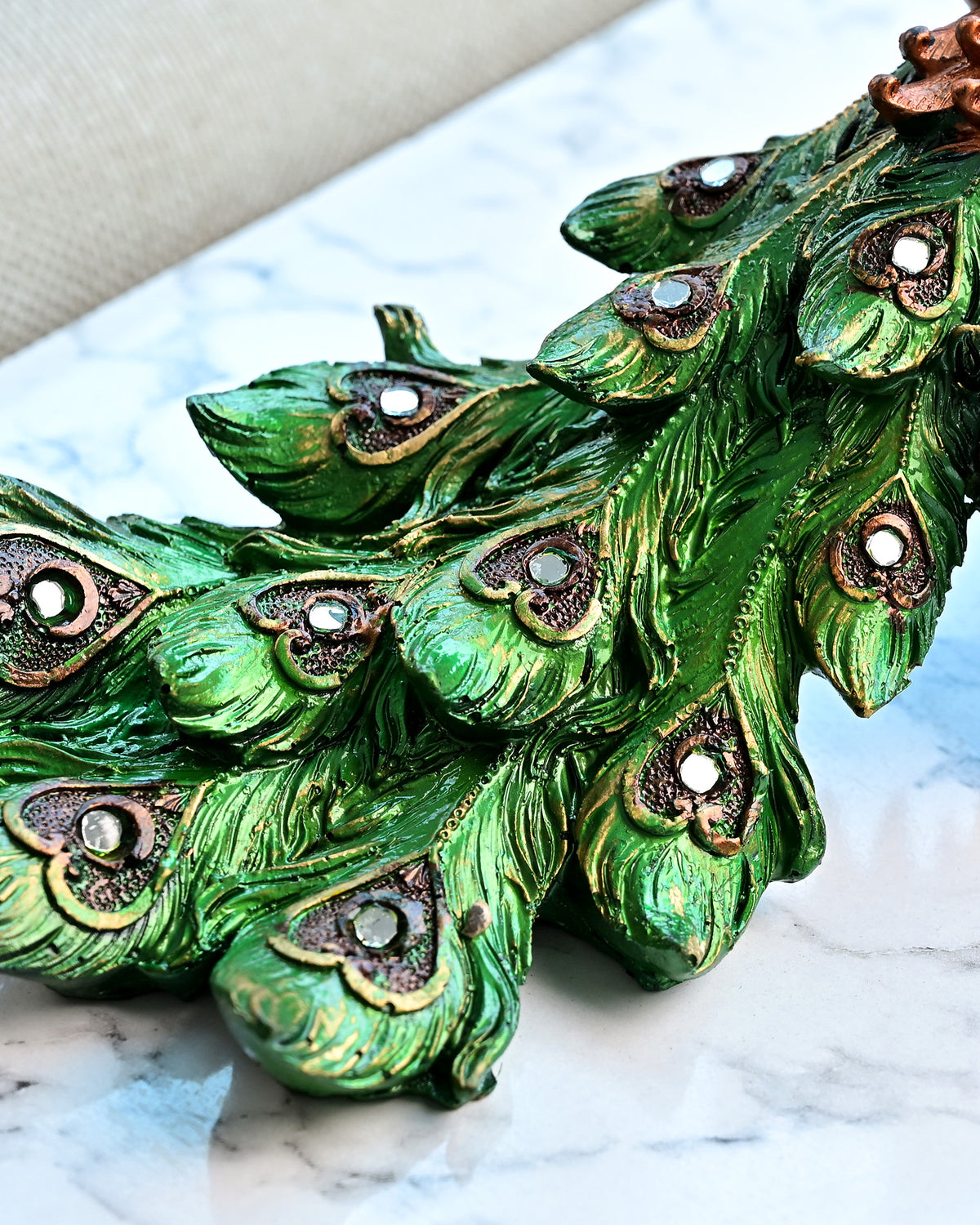 Artistic peacock sitting on a wooden tree trunk statue