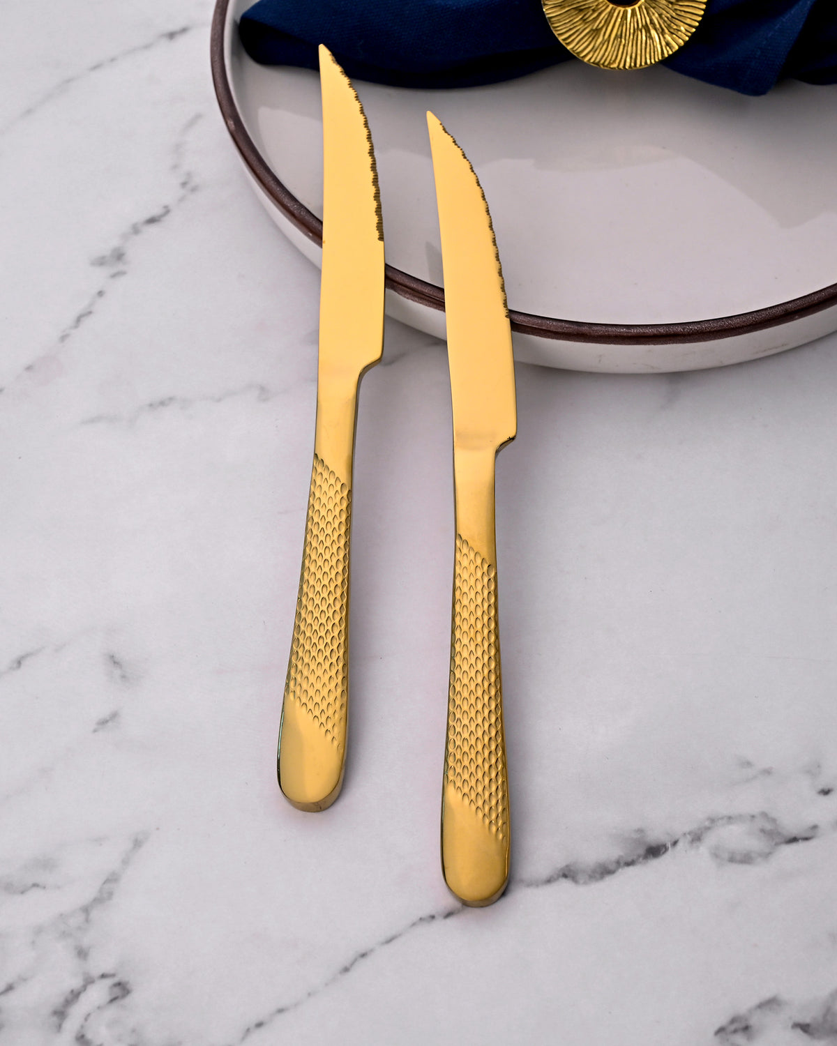 Close-Up View of Radiant Gold Knives with a Shiny Metallic Finish