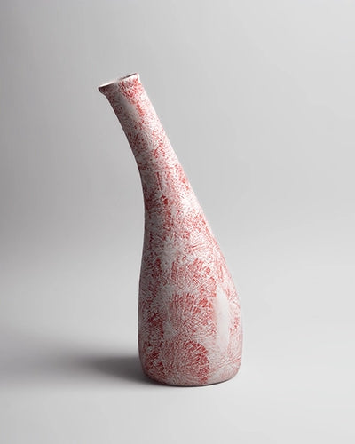 Decorative red and white vase featuring a textured finish