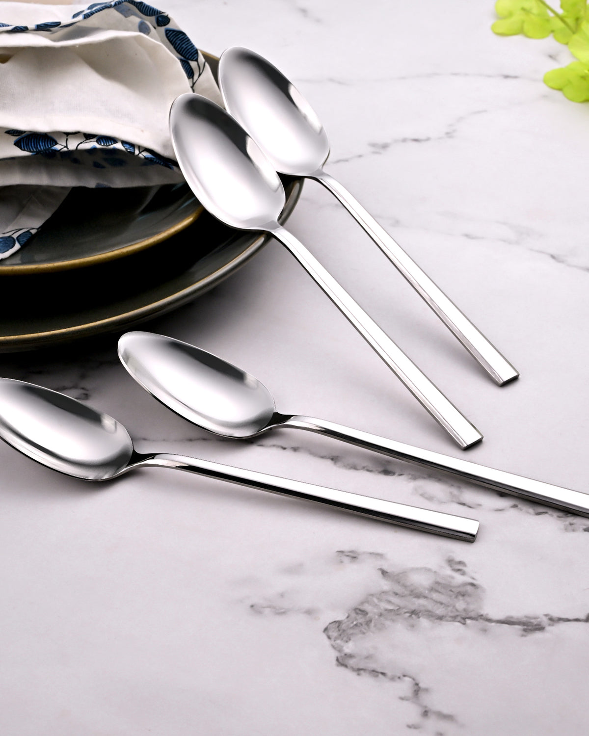Stylish Sleekline Steel Spoons Displayed with Elegant Tableware
