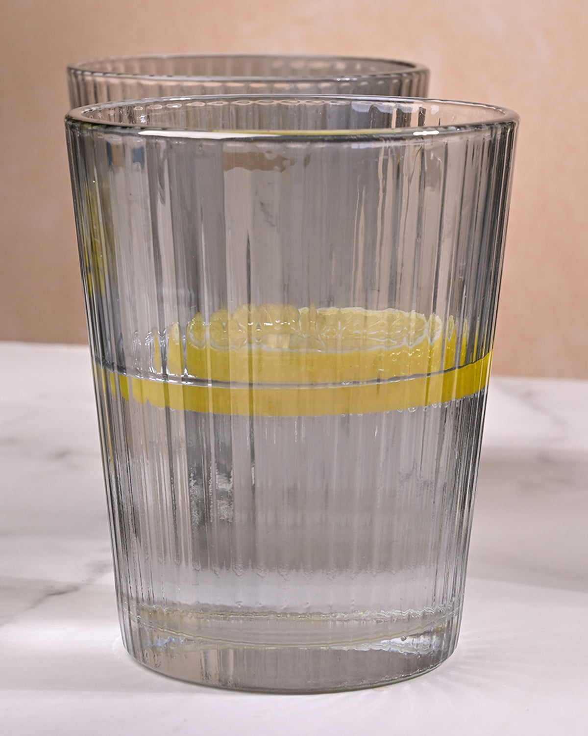 Minimalist grey-tinted glass jug and matching glasses for home use