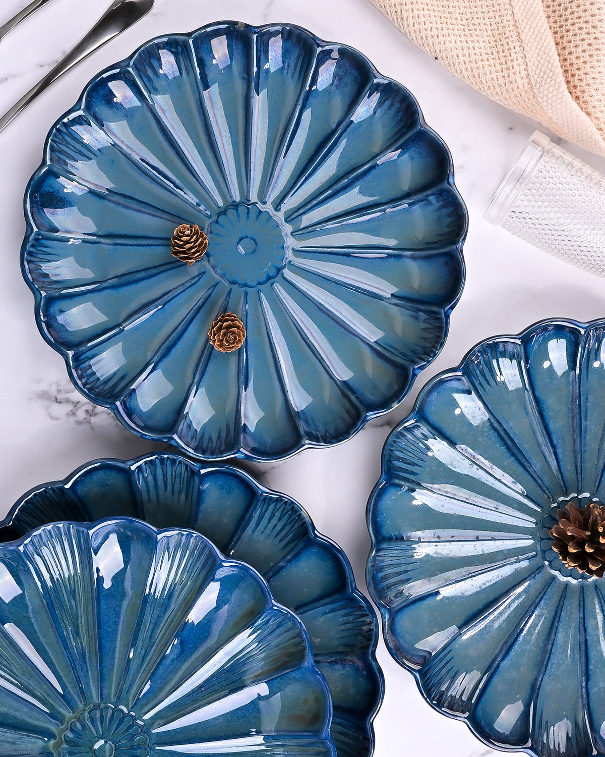 Set of four teal blue flower shaped plates