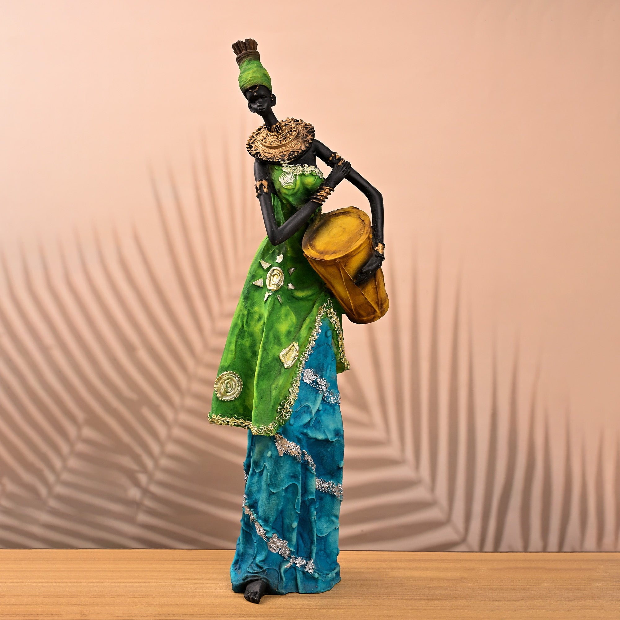 African woman holding drum statue with traditional design

