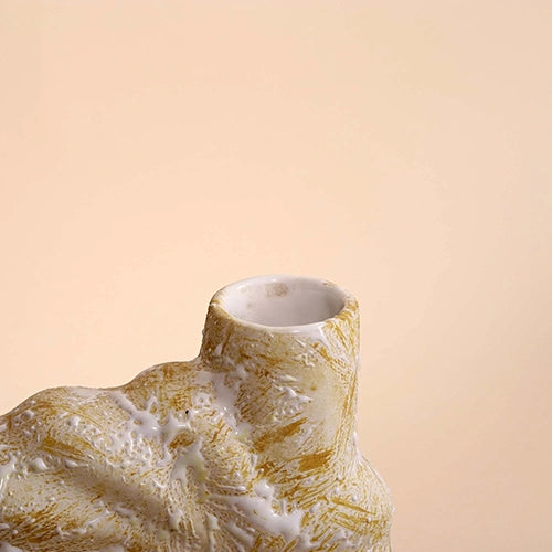 Beige flower vase with intricate shell detailing

