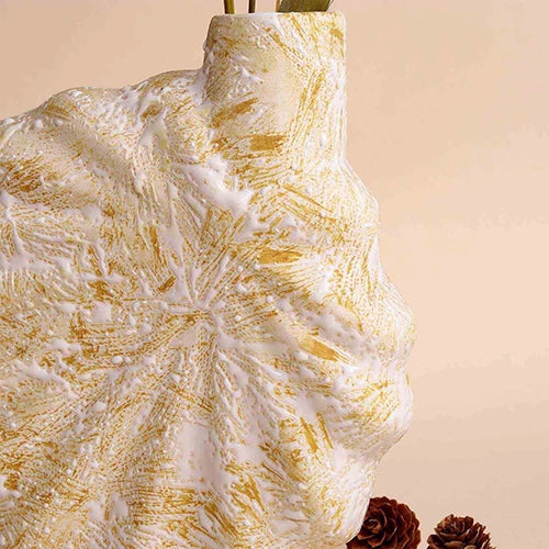 Stylish shell-inspired vase in a soft beige finish


