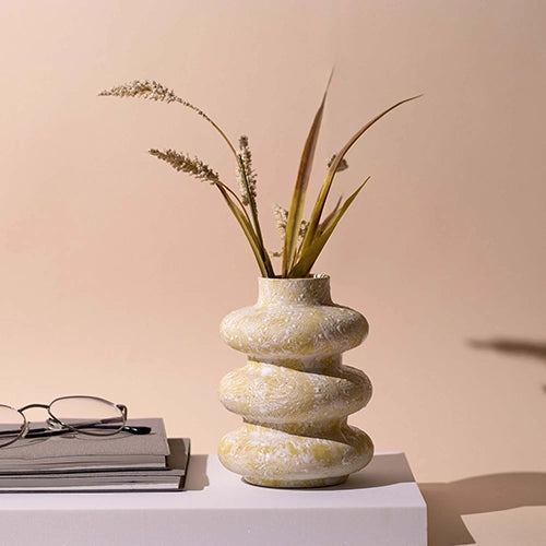 Beige tri-ring ceramic vase with modern sculptural design

