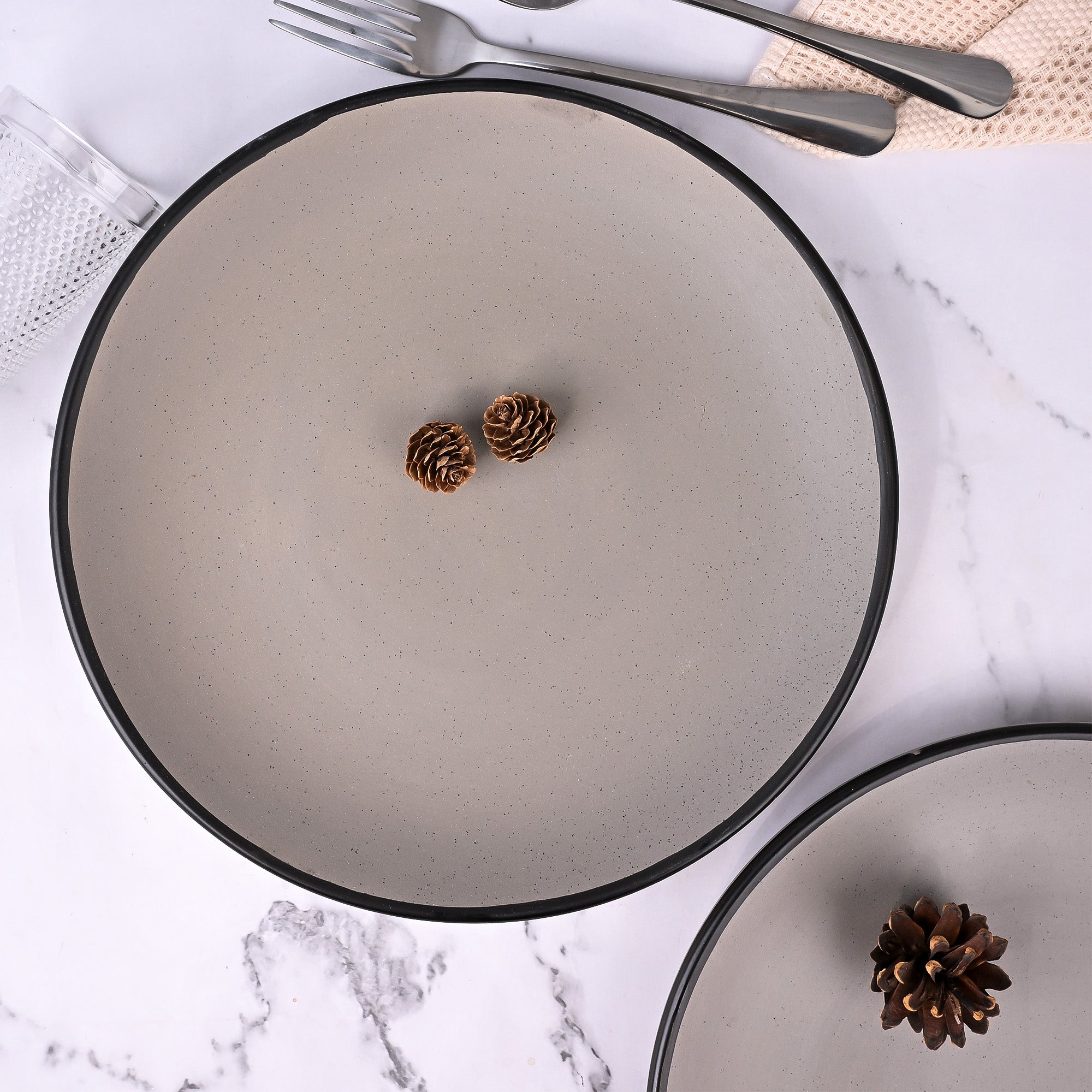 Grey ceramic dinner plates with black border

