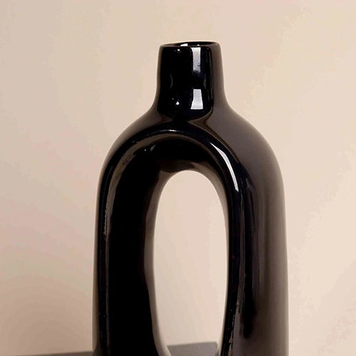 Sculptural black flower vase with a distinctive embrace design

