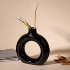 Black donut ring vase with modern sculptural design

