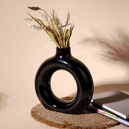 Minimalist black donut-shaped vase with unique design

