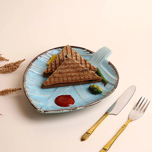 Decorative blue ceramic platter with leaf design


