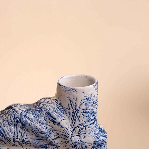 Blue flower vase with intricate shell detailing

