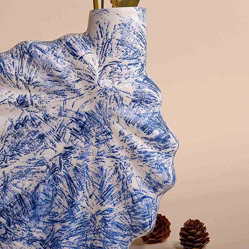 Stylish shell-inspired vase in a rich blue finish

