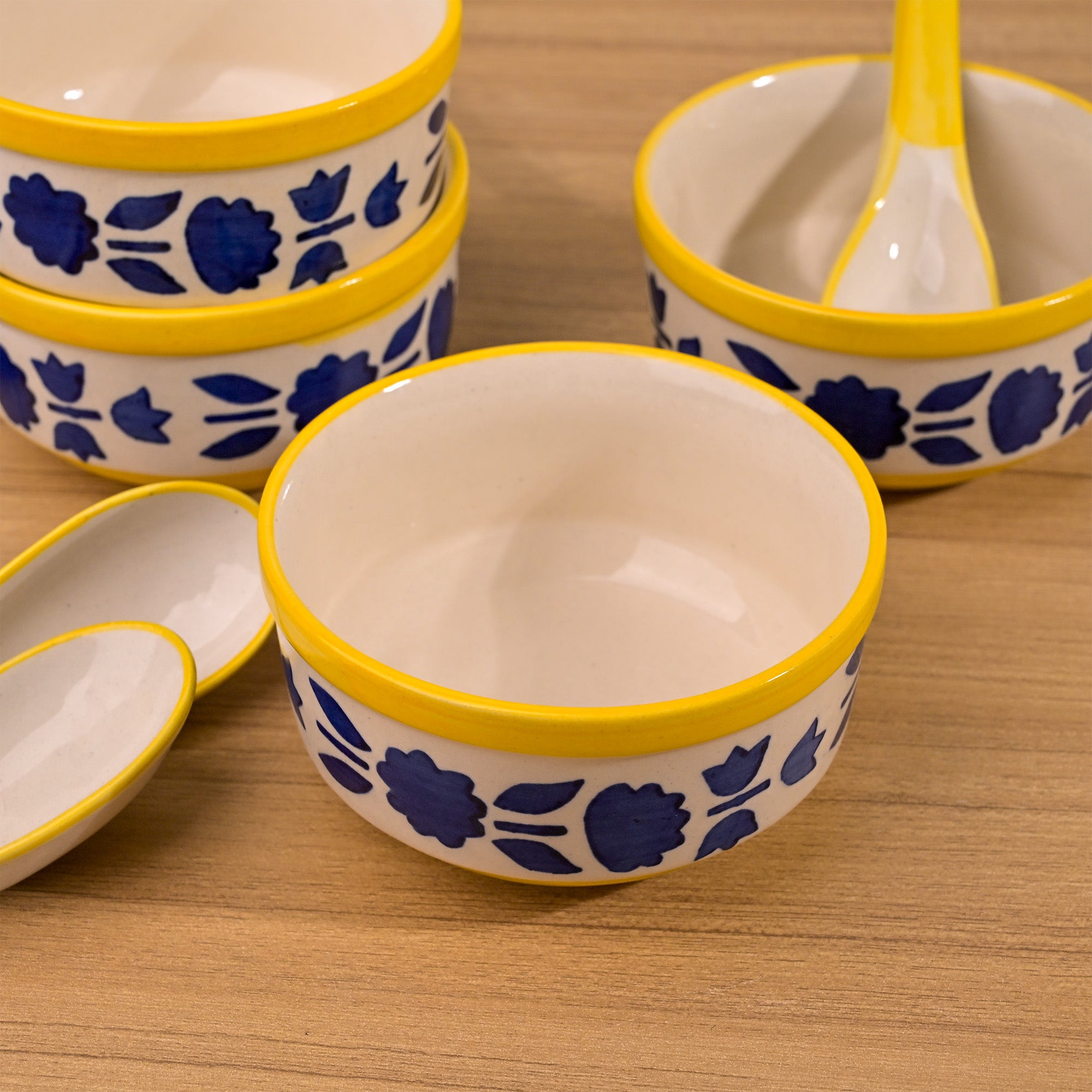 Decorative blue soup bowl set with four spoons

