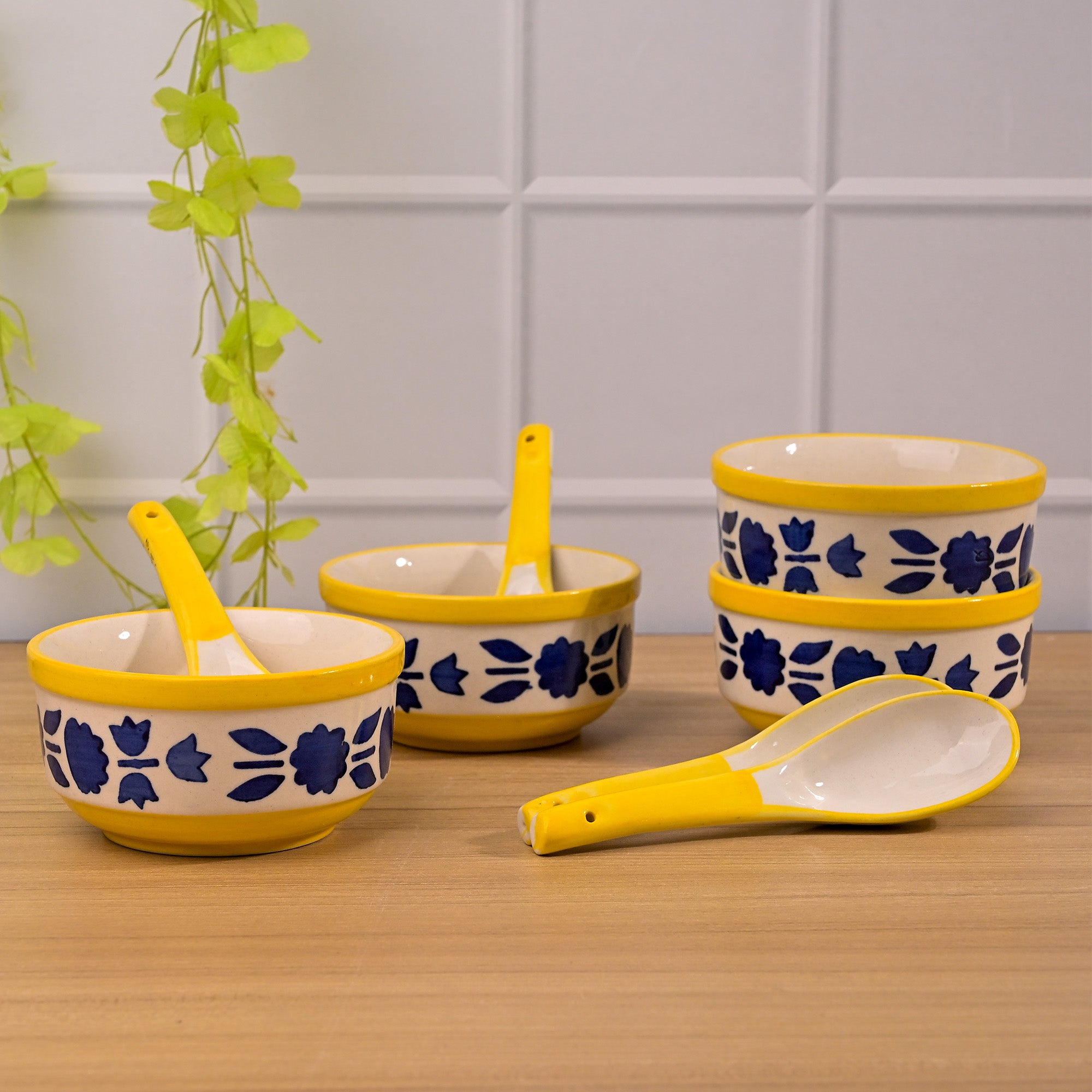 Set of four blue bowls with spoons for soups and stews

