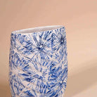 Textured blue vase with intricate botanical leaf detailing

