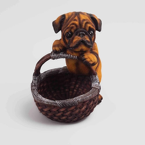Cute brown puppy sitting in a basket statue

