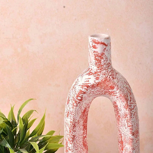 Sculptural coral hollow vase with an artistic open design

