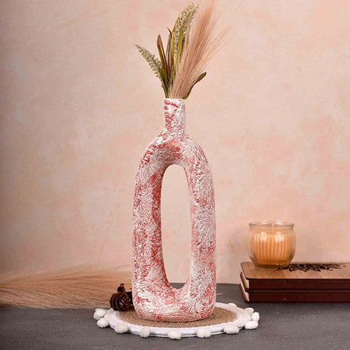 Artistic hollow flower vase in a vibrant coral ceramic finish

