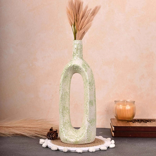 Ceramic pastel green hollow flower vase with modern sculptural design

