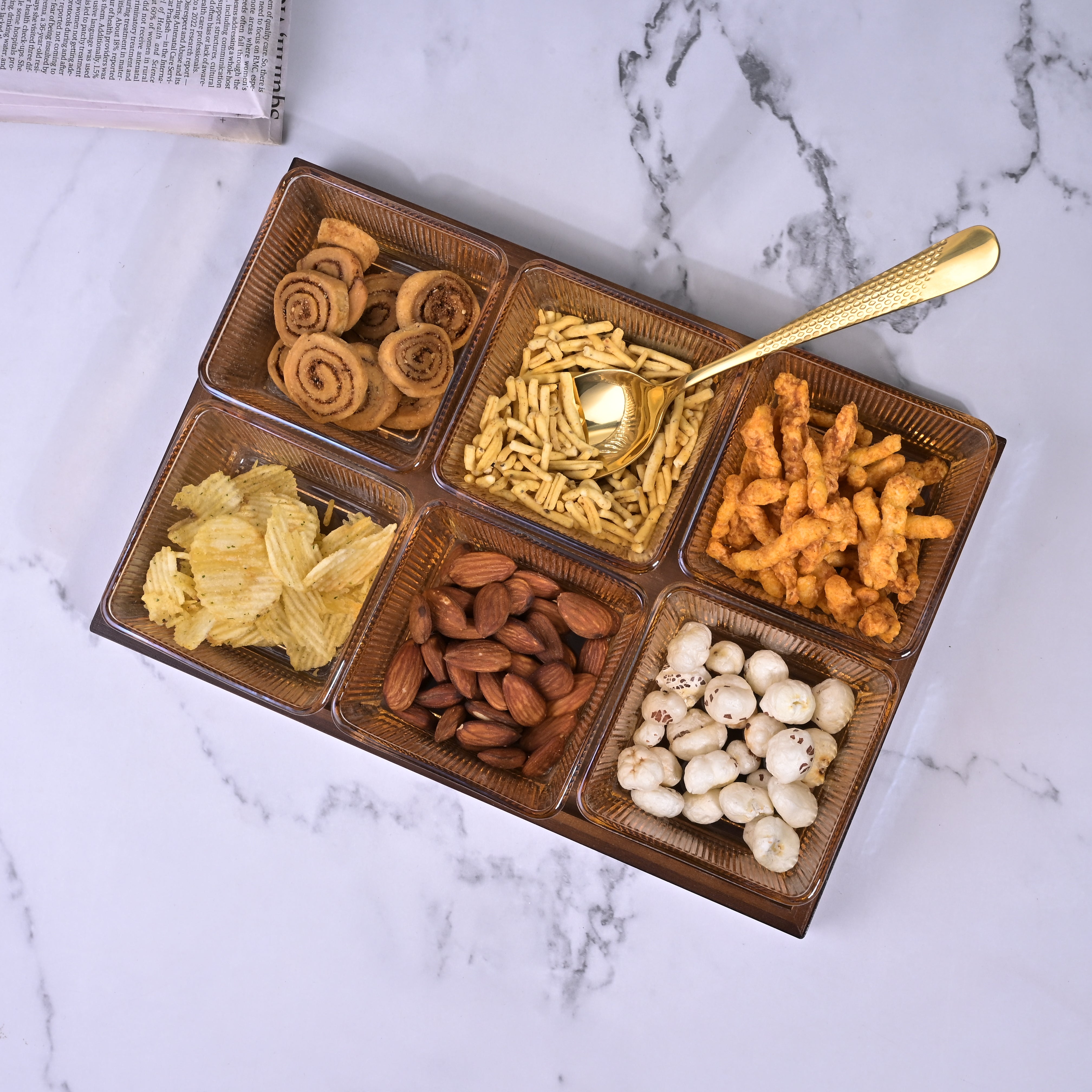 Decorative glass bowl arranged on brown tray

